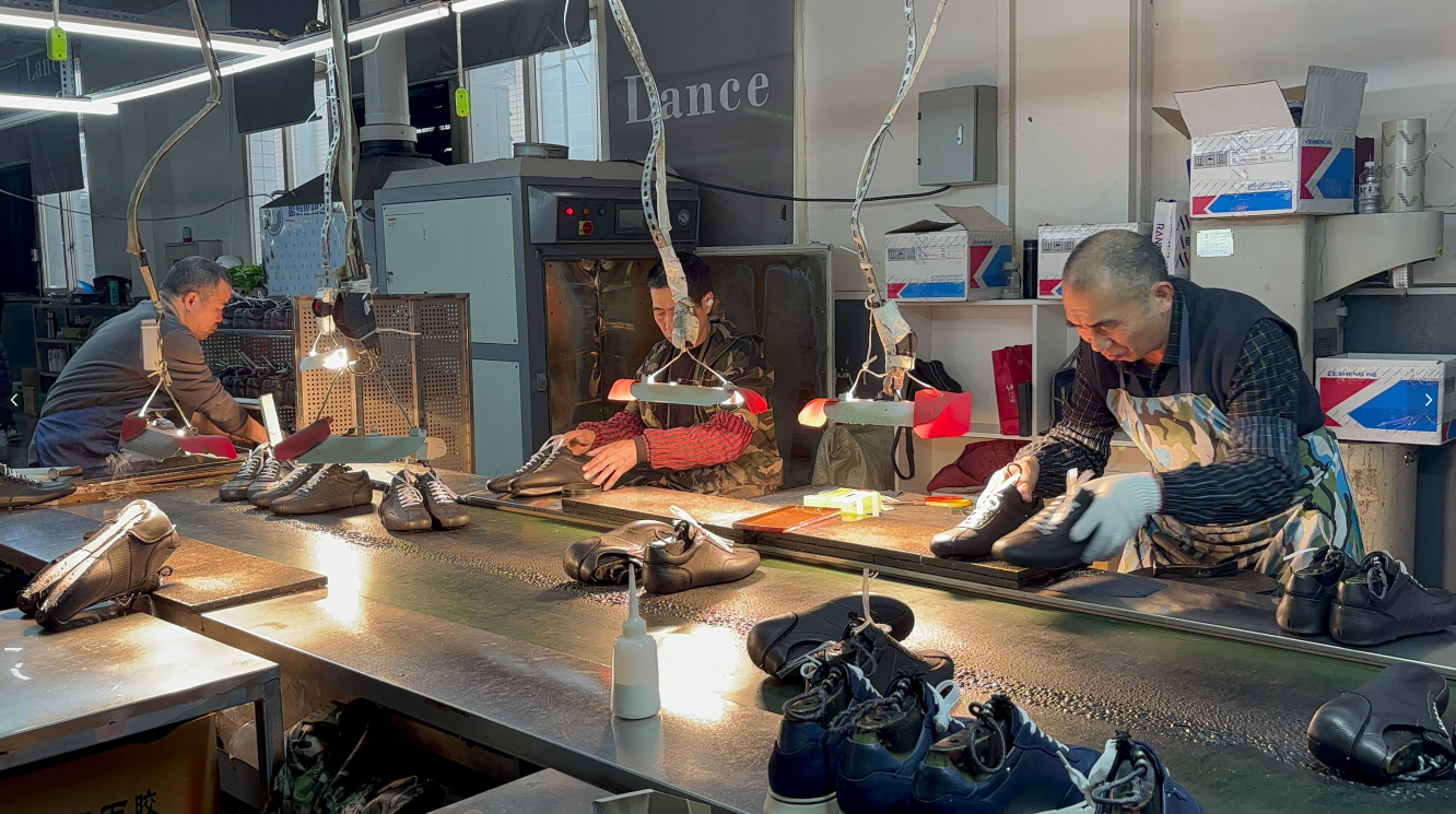 LANCI skilled workers handcrafting custom shoes on factory production line with professional lighting